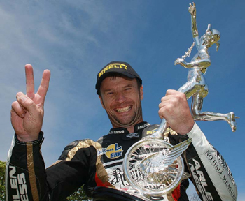 Bruce Anstey and his trophy for winning the Relentless Supersport Junior TT race two (Relentless by TAS Suzuki)